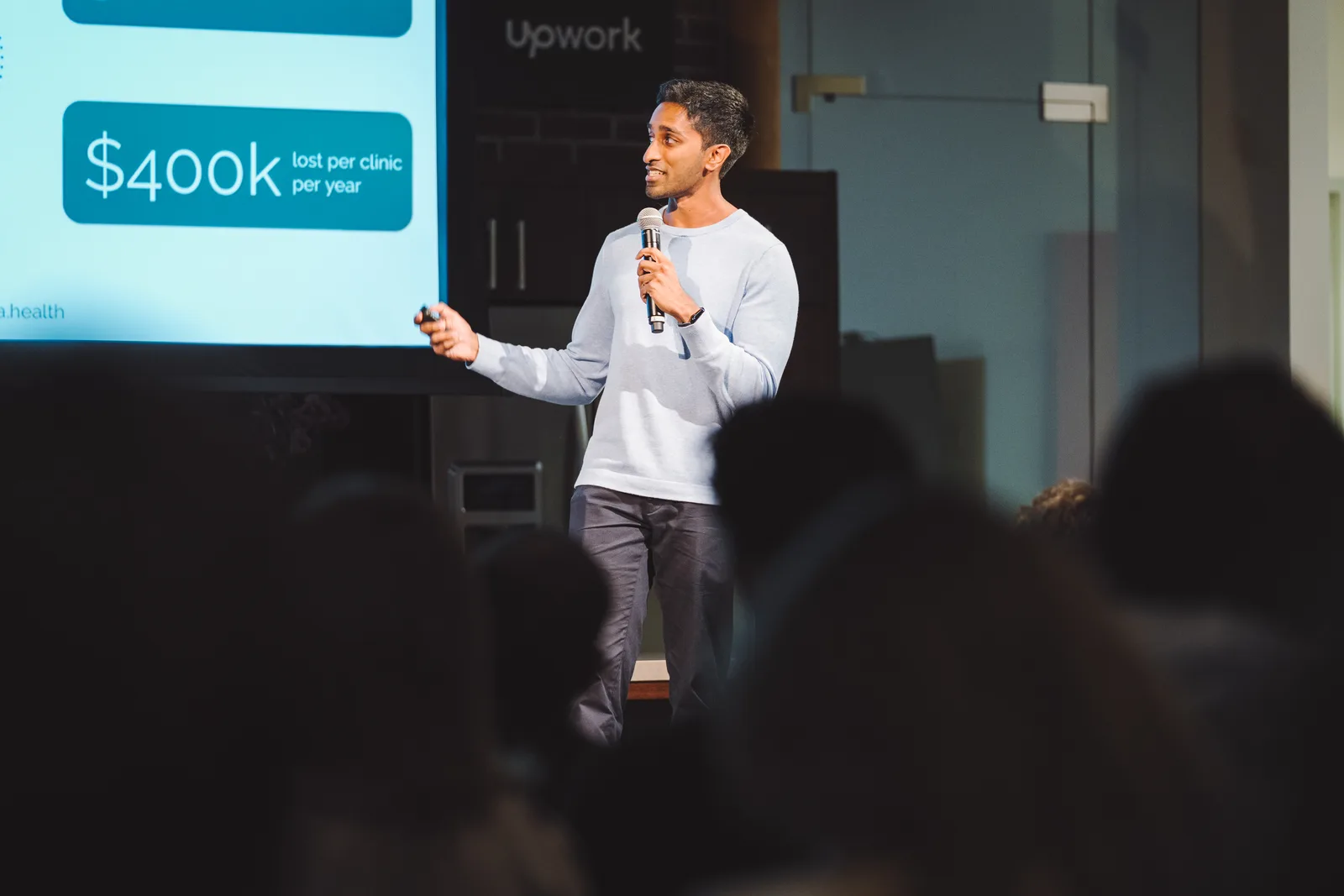 A founder presenting company progress to the room