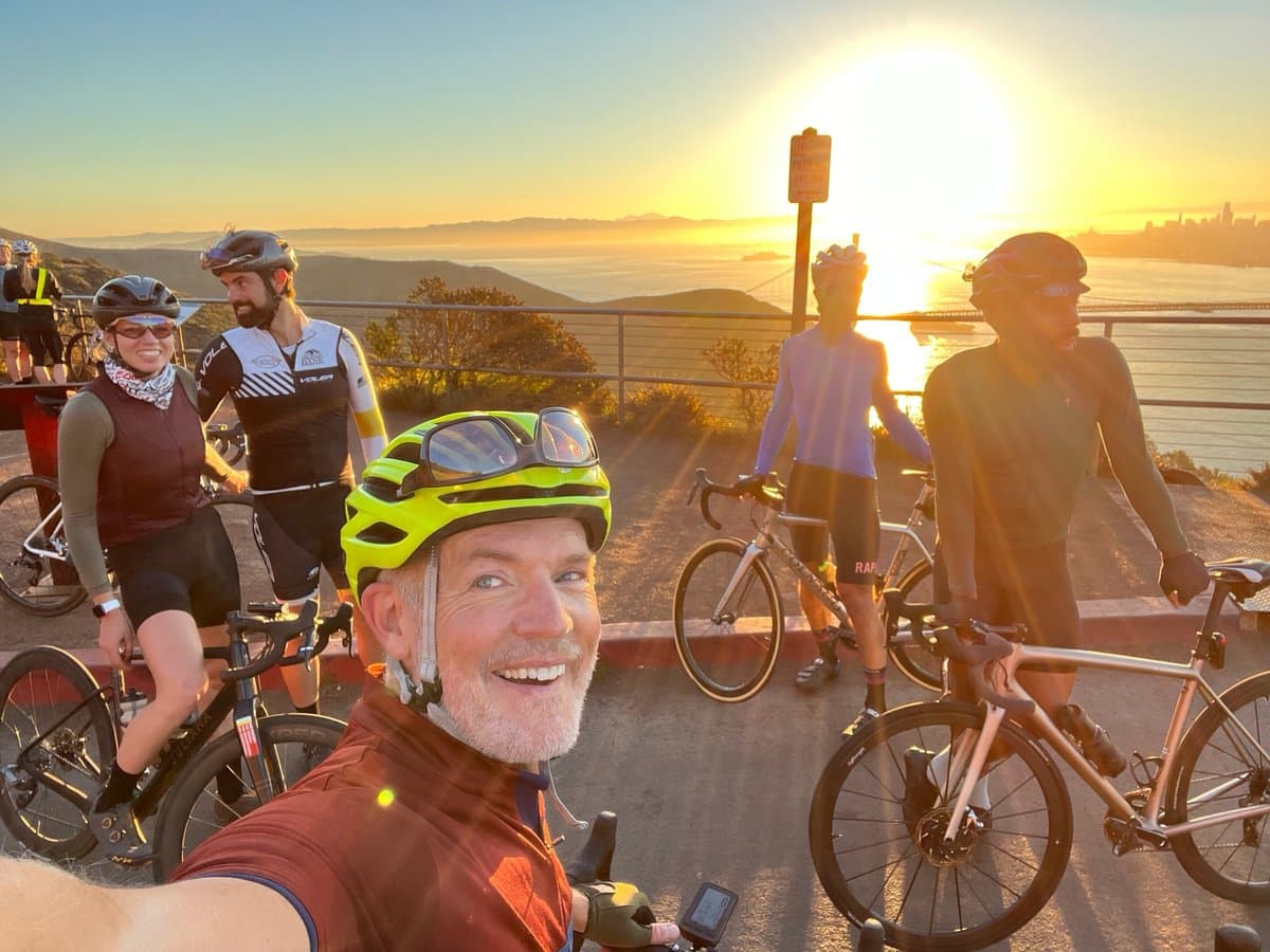 Startup Ride group selfie at sunset overlooking the San Francisco skyline